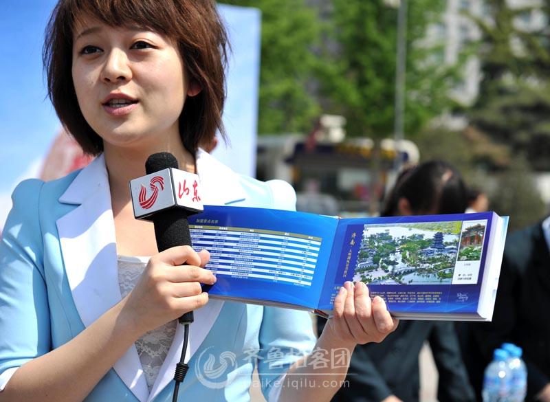 电视台记者向观众介绍旅游明信片册00.jpg